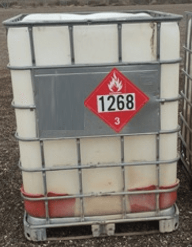 Placarded ISO tank container loaded on a transport trailer