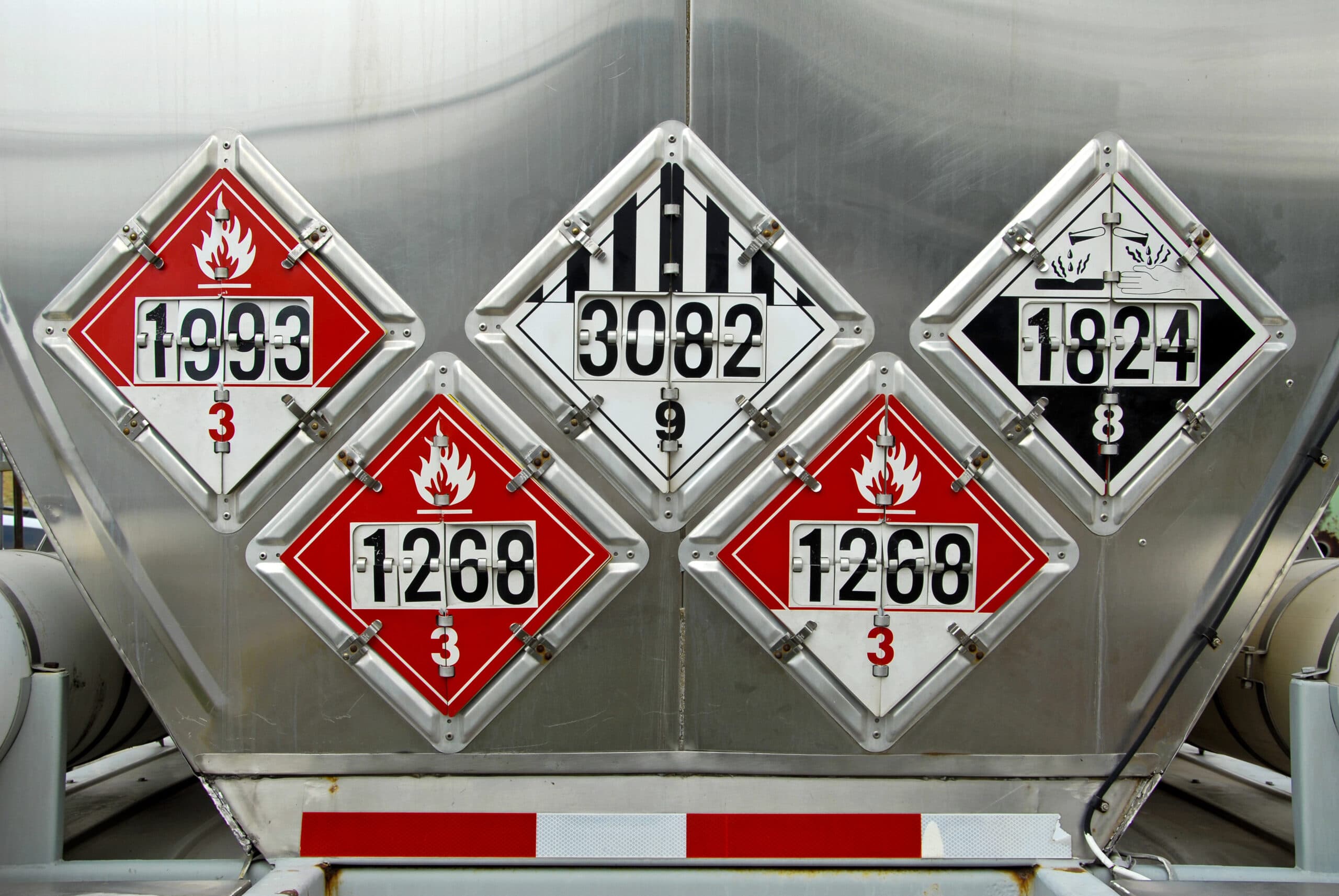 DOT hazard placards displayed on the back of a cargo tank