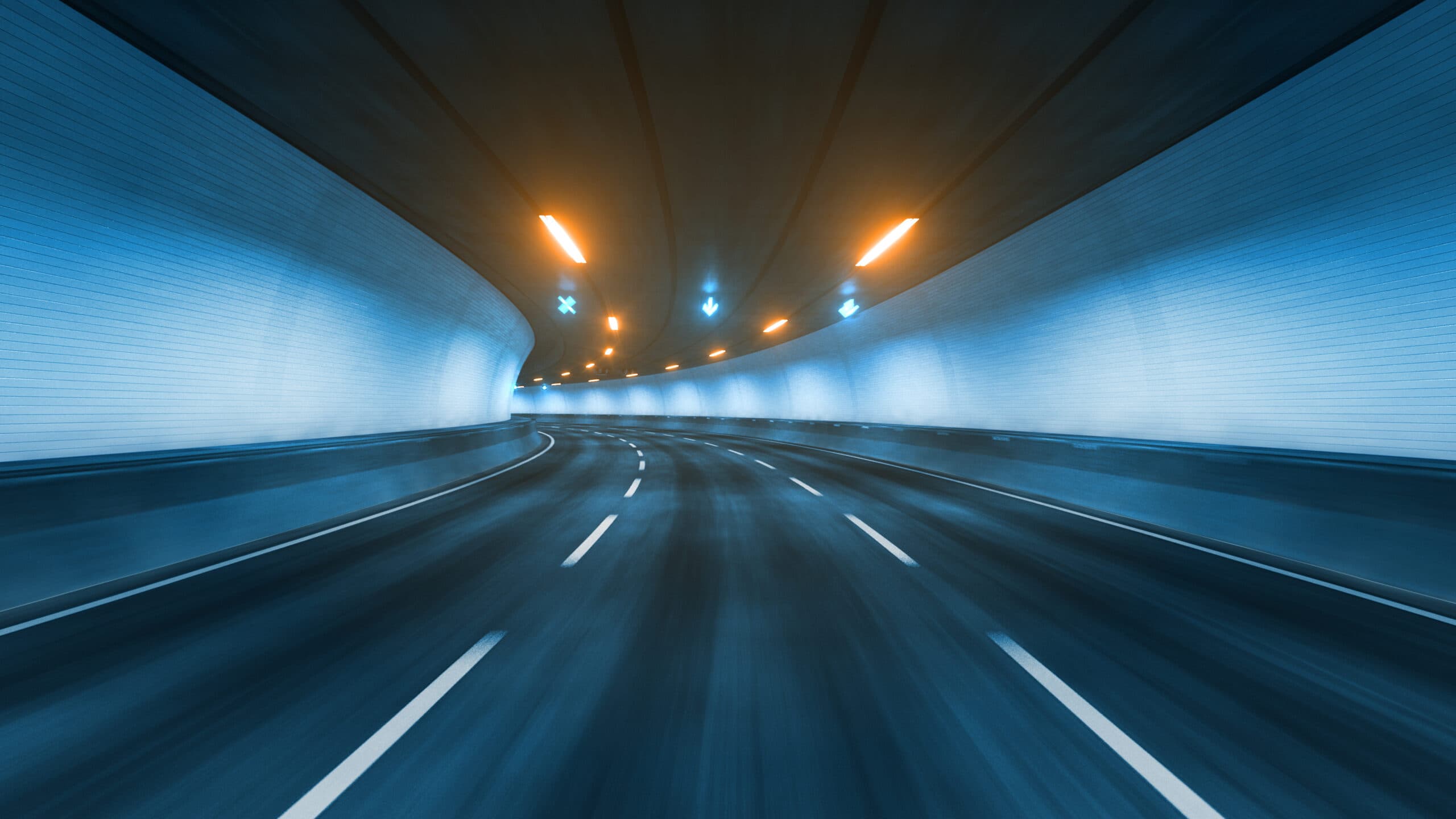 A blue highway tunnel with light streaks: the road ahead at DOT Training Solutions